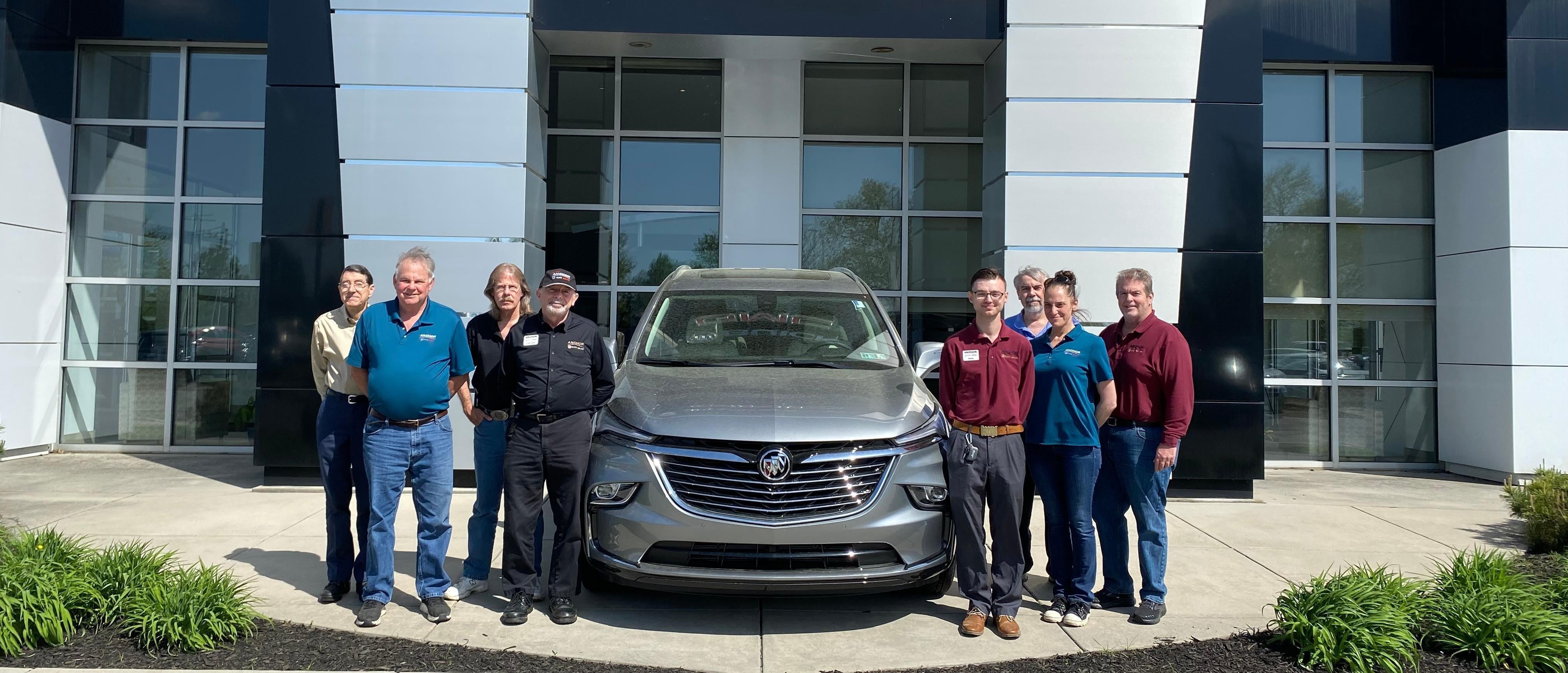 Anchor Buick GMC service department staff standing in front of a car, ready to assist with vehicle repairs and maintenance